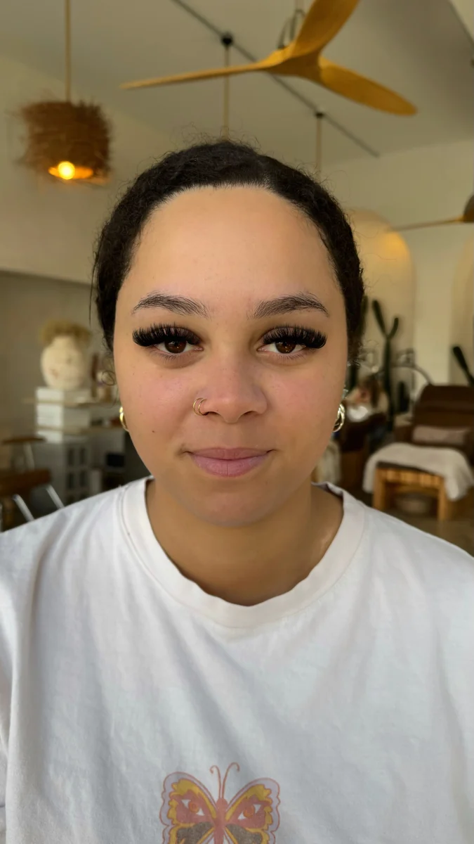 Client portrait showing full lashes and shaped brows